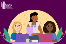 2 women sat at a desk on laptops and one women stood up behind them with a notepad and pen