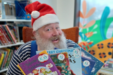 Father Christmas holding children's books